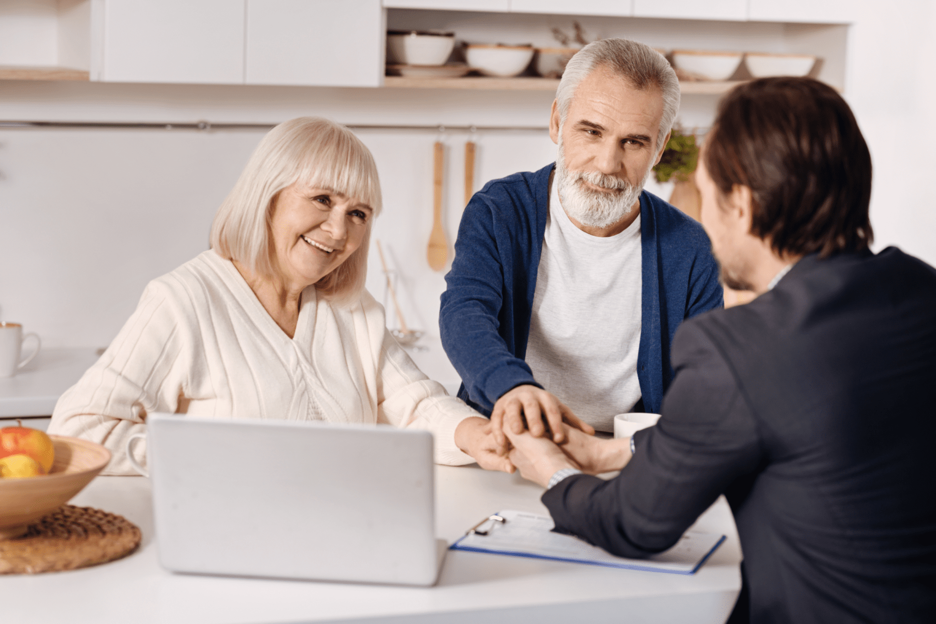 Real estate agent meeting with elderly couple of customers